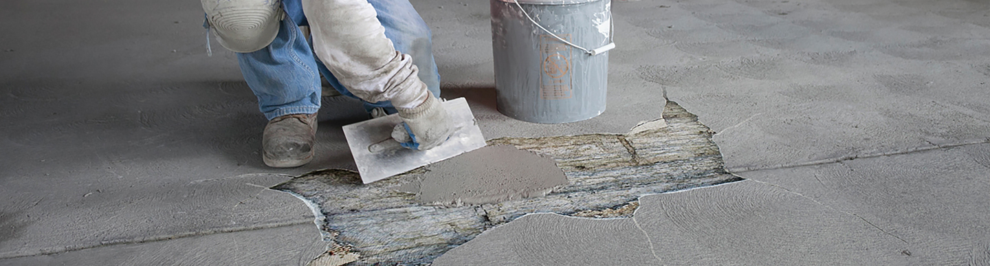 man-using-concrete-repair-tools-to-repair-concrete-cracks.jpg