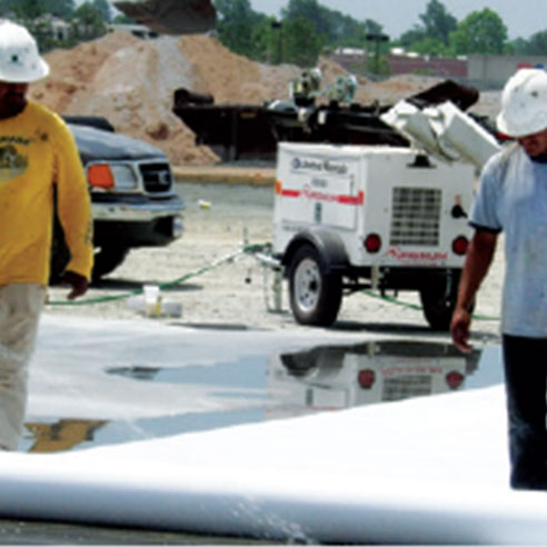 workers-unroll-concrete-curing-paper.jpg